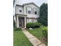 Inviting two-story home with lush green lawn, walkway, and tasteful landscaping at 12639 Justice Xing, Fishers, IN 46037