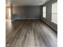 Spacious living room featuring modern, wood-look flooring and ample natural light at 12639 Justice Xing, Fishers, IN 46037