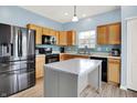 Bright kitchen featuring stainless steel appliances, wooden cabinets, and a stylish island at 1571 N Creekwater Pass, Greenfield, IN 46140
