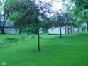 Expansive green backyard with mature trees and a shed at 1808 Orchid Ct, Indianapolis, IN 46219