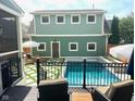 Backyard view of pool with lounge furniture and well-maintained lawn at 2050 N Alabama St, Indianapolis, IN 46202
