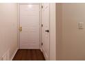 Entryway features a wood floor, a white front door, and a coat closet at 209 Faulkner Ct # 102, Carmel, IN 46032