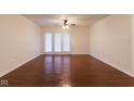 Open living room featuring hardwood floors, a ceiling fan, and white walls at 209 Faulkner Ct # 102, Carmel, IN 46032