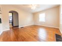 Bright living room with hardwood floors and ample natural light from two windows at 2249 Maple St, Columbus, IN 47201