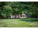 Spacious front yard with a beautiful brick home nestled among mature trees at 23119 Sonoma Ln, Cicero, IN 46034