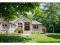 Inviting brick home with well-kept landscaping, flowers, and a welcoming front entrance at 23119 Sonoma Ln, Cicero, IN 46034