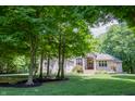 Well-maintained brick home with lush green lawn and mature trees providing privacy at 23119 Sonoma Ln, Cicero, IN 46034