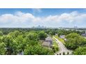 Scenic aerial view showcasing lush green trees, neighborhood streets, and the distant city skyline at 2524 E 17Th St, Indianapolis, IN 46218