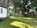 Large back yard with plenty of sunlight and a partial fence at 2631 Mcleay Dr, Indianapolis, IN 46220