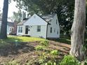 A view of the side and front of the home with a grassy lawn at 2631 Mcleay Dr, Indianapolis, IN 46220