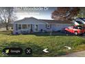 Charming single-story home with attached garage and well-maintained lawn in a suburban setting at 2875 E Woodside Dr, Mooresville, IN 46158