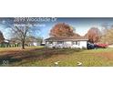 Single-story home with a brick exterior with a well-maintained front yard in a suburban neighborhood at 2875 E Woodside Dr, Mooresville, IN 46158