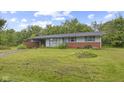 Charming single-story home with a brick base, light blue siding, and a spacious front yard at 31 Brooklyn Ct, Mooresville, IN 46158