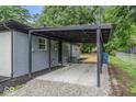Attached carport with gravel flooring and a covered area offering convenient parking at 360 Richie Ave, Indianapolis, IN 46234