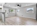 Bright living room featuring hardwood floors, new paint, and natural light from multiple windows at 360 Richie Ave, Indianapolis, IN 46234