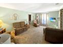 Inviting living room featuring plush sofas, a decorative display cabinet, and ample natural light at 4329 Rutgers Dr # 40B, Anderson, IN 46013