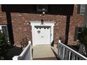 Inviting front entrance showcasing a bright white door with decorative accents and a brick facade at 44 Horseshoe Ln, Carmel, IN 46033