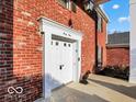 Exterior showing the brick facade and covered front entry with a decorative white door at 44 Horseshoe Ln, Carmel, IN 46033