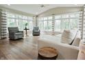 Bright living room featuring hardwood floors, neutral furniture and an abundance of natural light at 46 Hawthorne Ct, Carmel, IN 46033