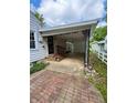 Carport and covered parking area with brick pathway and decorative iron supports at 472 N 17Th St, Noblesville, IN 46060