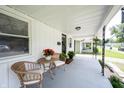 Cozy front porch with wicker furniture, potted plants, and covered ceiling at 4927 Caroline Ave, Indianapolis, IN 46205