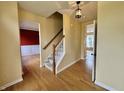 Inviting foyer with hardwood floors, staircase, and views into the adjacent living spaces at 5571 Auburndale Dr, Bargersville, IN 46106