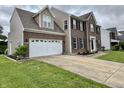 Brick and siding home featuring an attached garage and a concrete driveway at 5571 Auburndale Dr, Bargersville, IN 46106