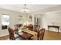 Elegant dining room with a chandelier, classic furniture, and plenty of natural light from the window at 6050 Acorn Dr, Columbus, IN 47201