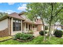 Beautiful two-story home with brick and vinyl siding, a cozy porch, and lovely landscaping at 6050 Acorn Dr, Columbus, IN 47201