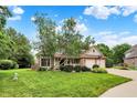 Charming two-story home with well-maintained lawn and two car garage on a sunny day at 6050 Acorn Dr, Columbus, IN 47201