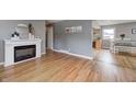 Inviting living room featuring hardwood floors, a cozy fireplace, and neutral decor for a modern touch at 6143 Schoolwood Dr, Indianapolis, IN 46224