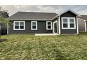 Exterior showcasing a gray home with white trim, and a cozy patio overlooking the lawn at 6729 Birmingham Ave, McCordsville, IN 46055