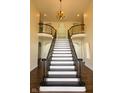 Elegant foyer features a grand staircase with wrought iron railings and hardwood floors at 7493 W Lane Rd, McCordsville, IN 46055