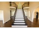 Elegant foyer features a grand staircase with wrought iron railings and hardwood floors at 7493 W Lane Rd, McCordsville, IN 46055