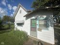 A vintage home with covered windows, wood siding and a screened in door at 815 N 12Th St, Elwood, IN 46036