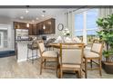 Stylish kitchen features stainless steel appliances, granite counters, a breakfast bar and an adjacent dining area at 8568 Goldfinch Rd, Brownsburg, IN 46112