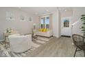 Bright living room with light walls, wood floors, lots of natural light, and stylish neutral furniture at 8568 Goldfinch Rd, Brownsburg, IN 46112