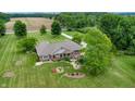 A bird's-eye view of the property featuring a patio with outdoor seating and well-maintained greenery at 8818 Mathews Rd, Indianapolis, IN 46259