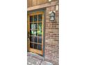 Glass panel front door with red brick, and an antique lantern lamp at 8875 N Goat Hollow Rd, Mooresville, IN 46158