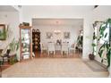 Inviting dining room with chandelier, glass table, wood floors, and access to entryway at 10601 Adam Dr, Indianapolis, IN 46231