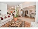Bright, open floorplan with elegant furnishings, decor, wood and tile flooring, and lots of plants at 10601 Adam Dr, Indianapolis, IN 46231