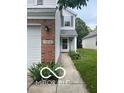 A charming home with a gray exterior and brick accents, complemented by a well-maintained walkway at 11532 Glenn Abbey Ln, Indianapolis, IN 46235