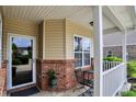 Inviting front porch detail with brick accents, neutral siding, and space for outdoor seating at 1163 Meadowlark Dr, Greenwood, IN 46143