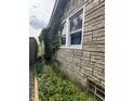 Stone exterior of home covered with plants and a small yard at 1214 Wallace Ave, Indianapolis, IN 46201