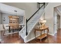 Open foyer showcases a staircase with wood floors, and views of the dining area with a large table at 12234 Limestone Dr, Fishers, IN 46037