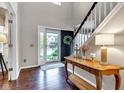 Welcoming foyer with hardwood floors, a staircase with white risers, and stylish decor at 12234 Limestone Dr, Fishers, IN 46037