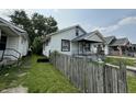 Modest home showing a side view from the yard, with the home needing TLC at 1226 Hiatt St, Indianapolis, IN 46221