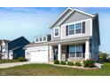 Beautiful two-story home with stone accents, a covered porch, and a well-manicured lawn at 1328 Plover Dr, Greenwood, IN 46143