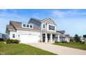 Well-maintained two-story home with a spacious driveway and a neatly landscaped front yard at 1328 Plover Dr, Greenwood, IN 46143