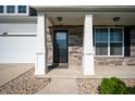 Inviting front porch with stone pillars and a decorative front door at 1328 Plover Dr, Greenwood, IN 46143
